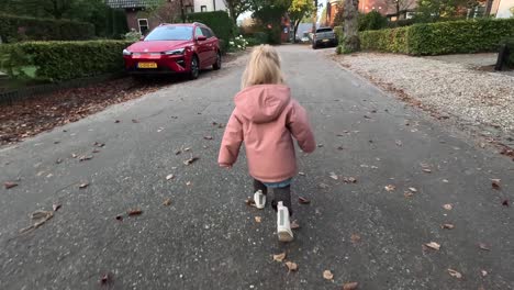 small child walking in a european town.
