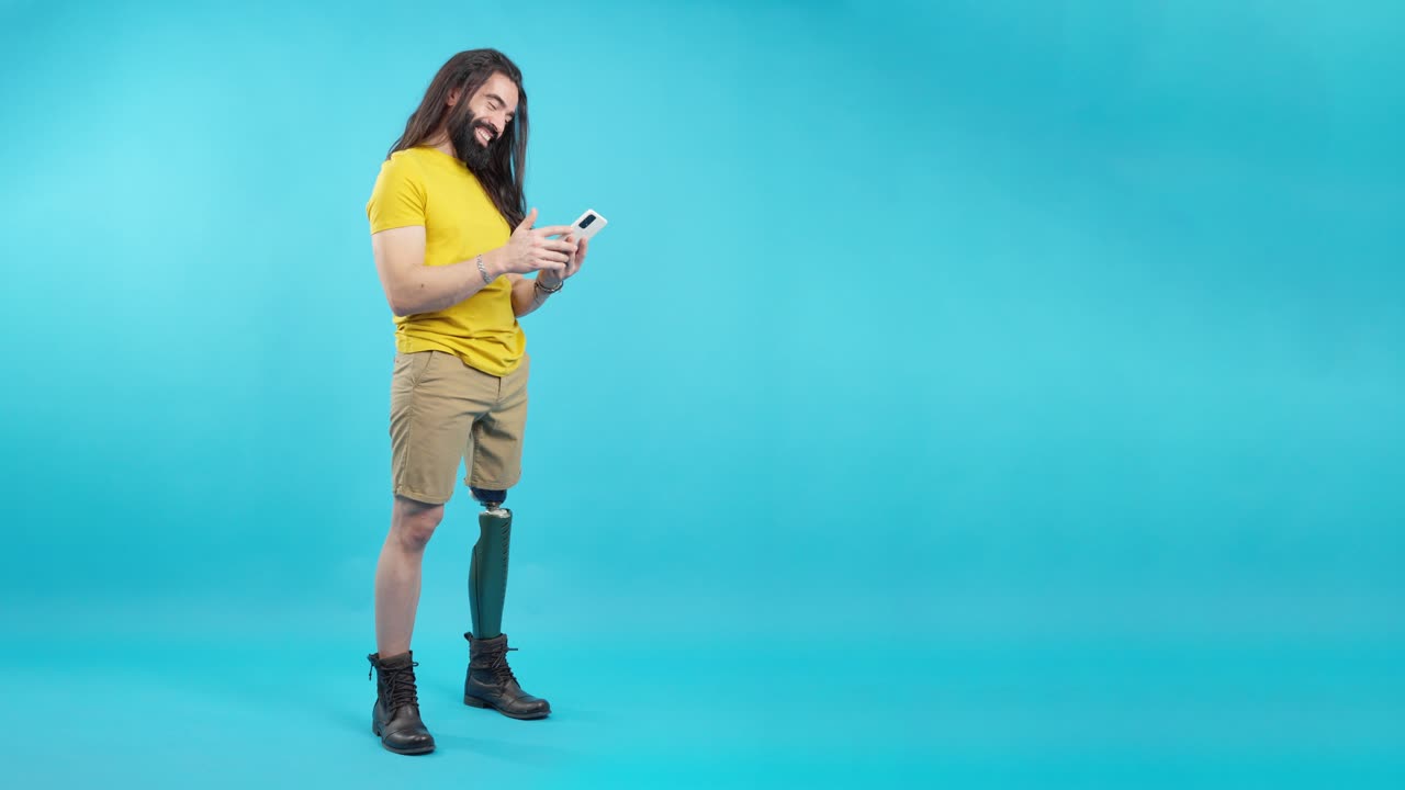 Happy man with prosthetic leg using a smartphone