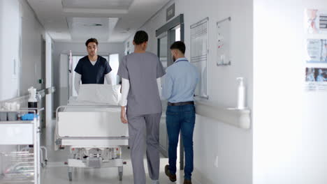 healthcare professionals transport a patient in a hospital corridor