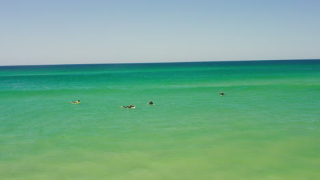 aerial: surfing the beach of bordeira in the algarve, portugal