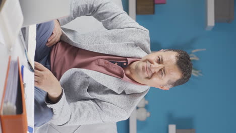 vertical video of home office worker old man looking emotional at camera.