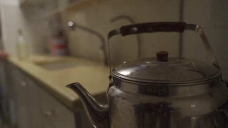 taking-kettle-off-stove-for-making-coffee-in-the-morning-in-slow-motion