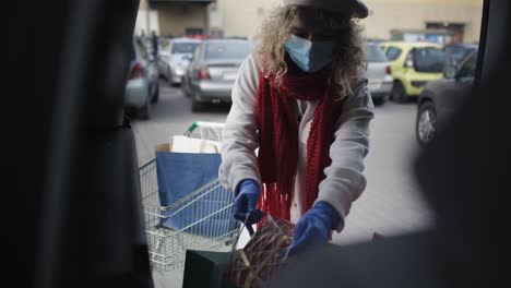 Video-of-Woman-putting-shopping-bags-in-the-car-trunk