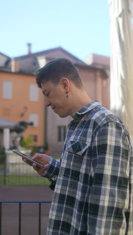 young man using smartphone outdoors