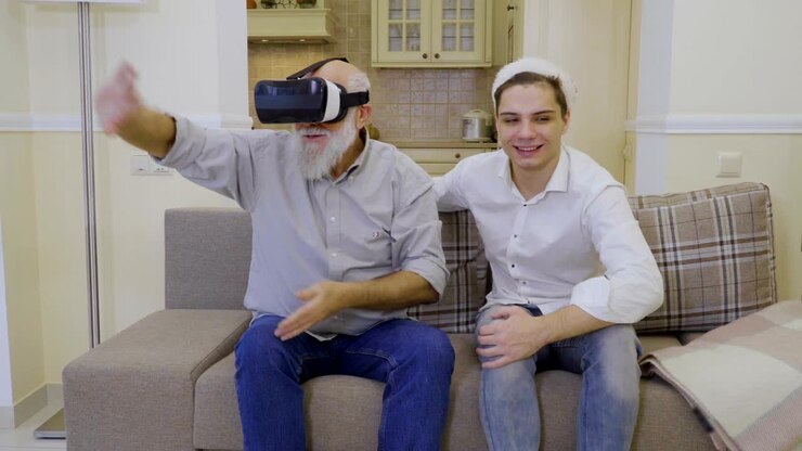 Nonno con nipote usa occhiali per la realtà virtuale.