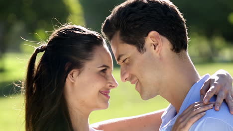 Loving-couple-standing-in-the-park-