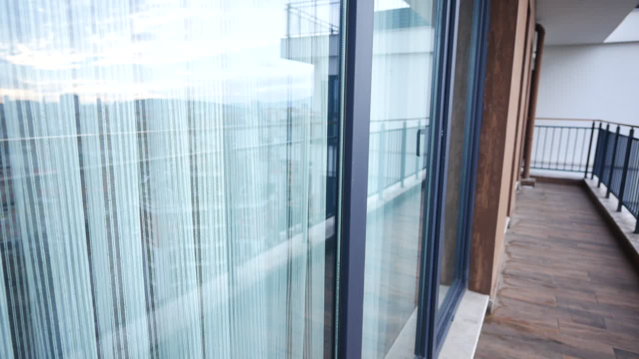 Apartment Balcony with Sliding Glass Doors and Curtains