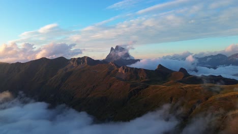 drone shot of pyrenees landscape with "middi d'ossau", a famous french mountain at background in ibones de anayet, aragón, spain