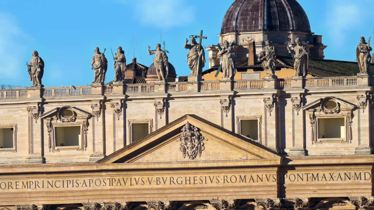 Statues on Saint Peter's Basilica at sunset in Rome, Italy