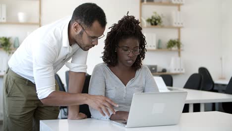 front view of concentrated employees working with laptop