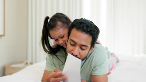 Father,-child-and-reading-a-card-in-a-family-home