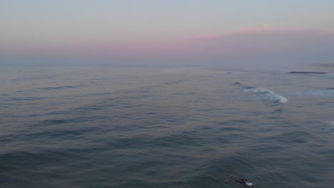 surfer-hanging-out-in-the-ocean-at-holden-hour