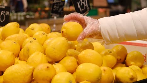 girl buys lemon in the supermarket, citrus, healthy food. vitamin c, natural vitamins