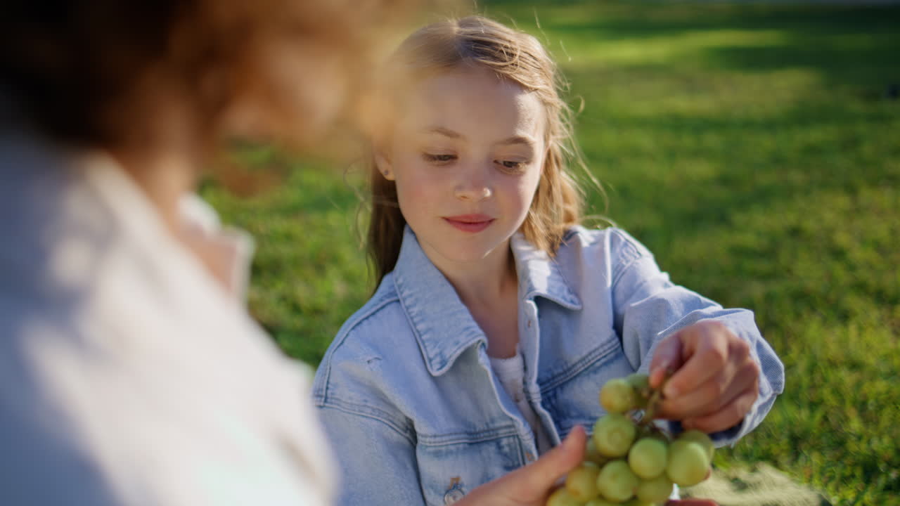Cute daughter picnic park talking mother at sunny day closeup. Mom kid weekend