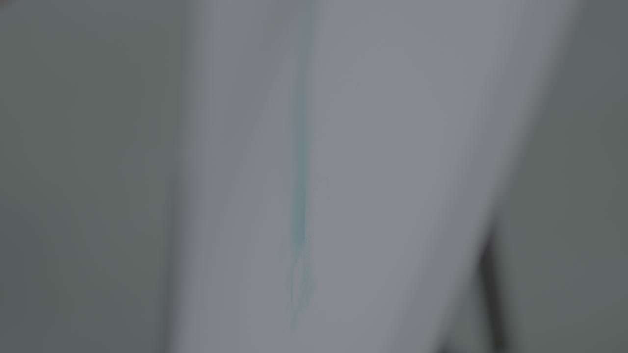 Woman painting a wall with a brush