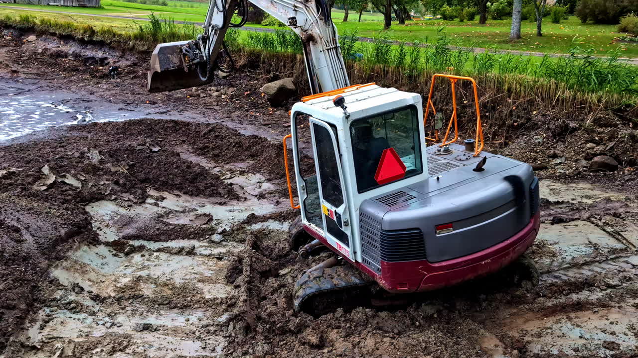 Mini Excavator Stuck in Mud During Construction Work