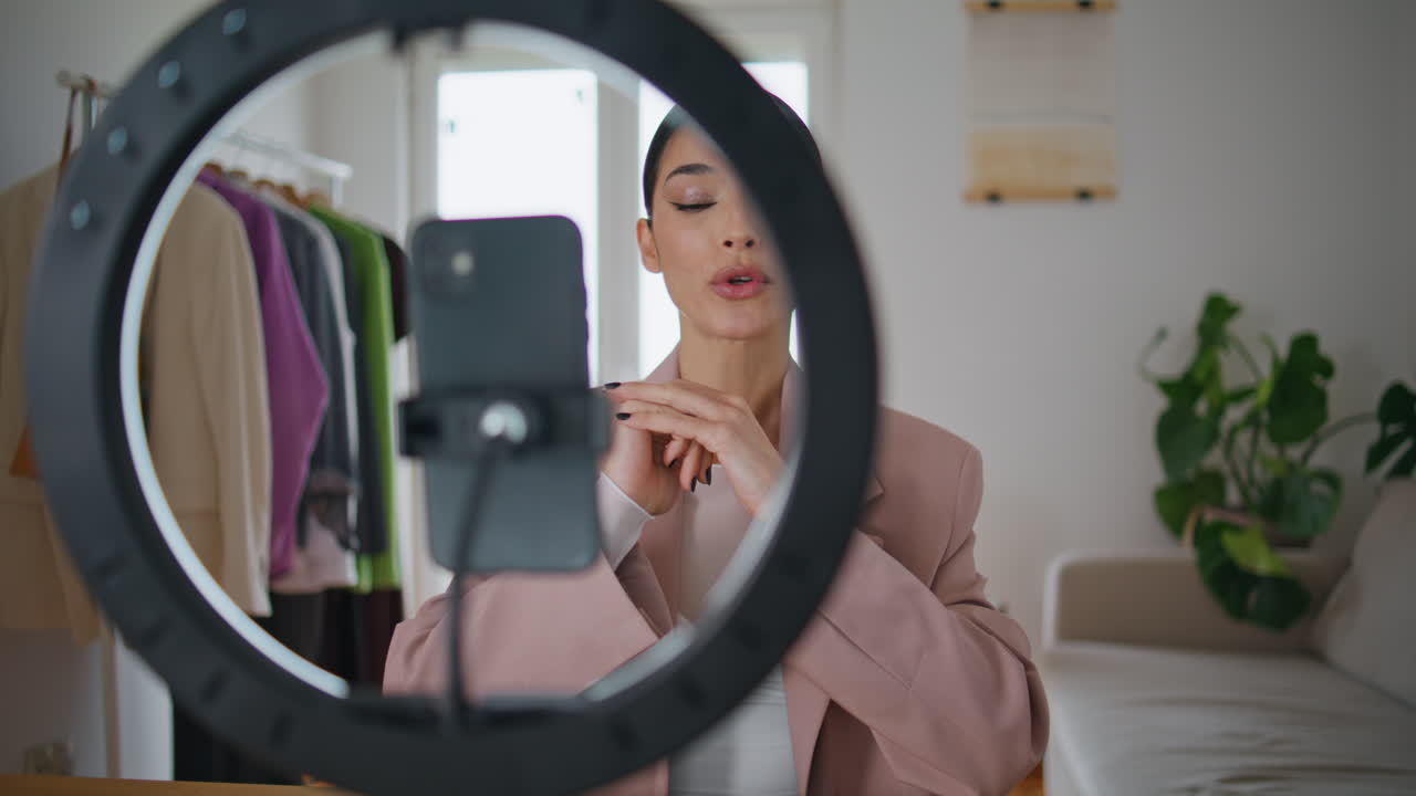 Blogger woman filming makeup tutorial at house closeup. Talking girl review