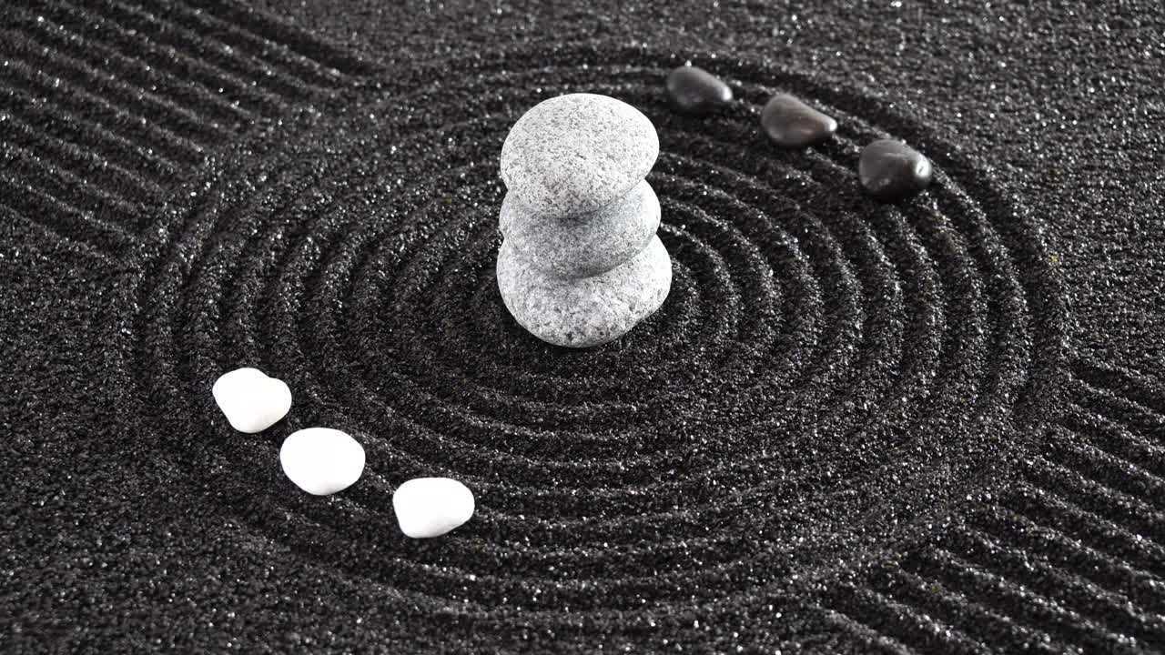 Japanese garden with yin yang stones laying in textured sand