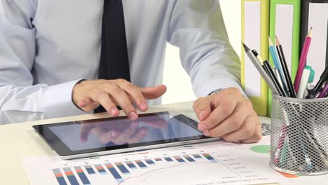 businessman using tablet with financial data