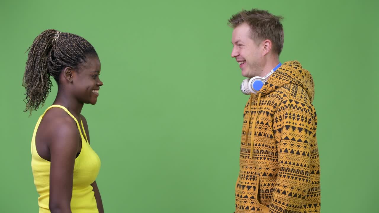 Young multi-ethnic couple giving high-five together