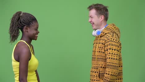 young multi-ethnic couple giving high-five together