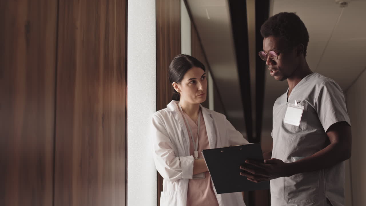 Doctors and Nurses Consulting in Hospital Corridor