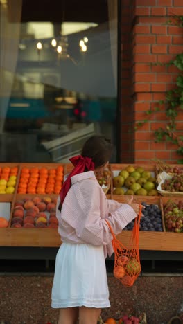 woman shopping for fruit at a grocery store