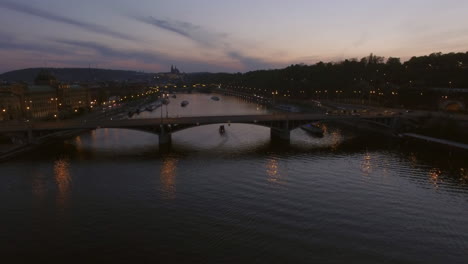 flying over prague manes bridge view in the dusk