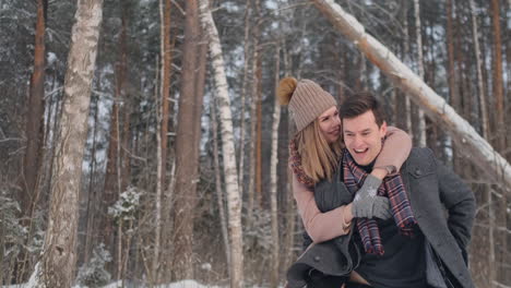 young beautiful couple taking fun and smiling outdoors in snowy winter