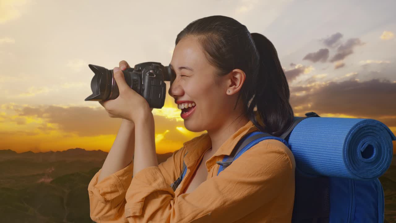 Woman Traveler Taking Pictures of Sunset Over Mountains