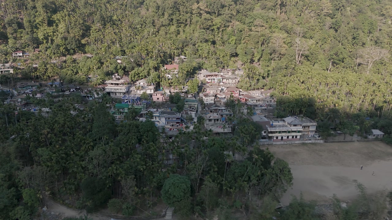 Aerial view of Shnongpdeng village built on a steep, jungle-covered mountainside in the gorges of Meghalaya, India.
