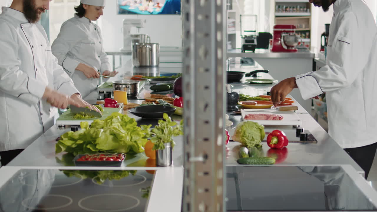 Portrait of man in uniform preparing green salad on cutting board