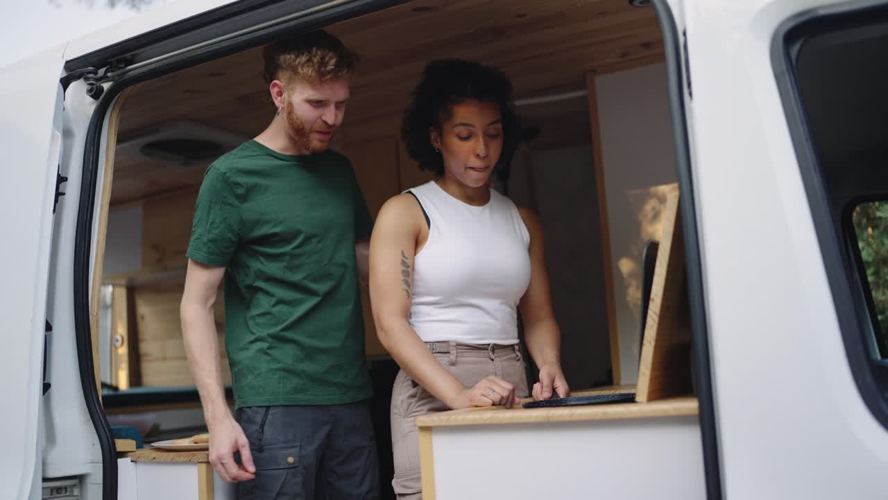 Couple cooking in a van