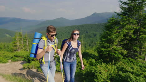 a young married couple is climbing a mountain active and healthy lifestyle 4k video