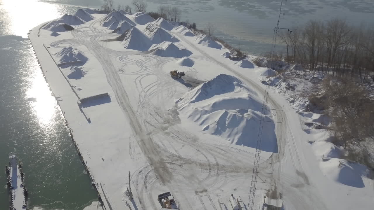 A Loader At Work On The Snowy Sand Port In Kingsville, Ontario, Canada On A Sunny Day - Aerial Shot