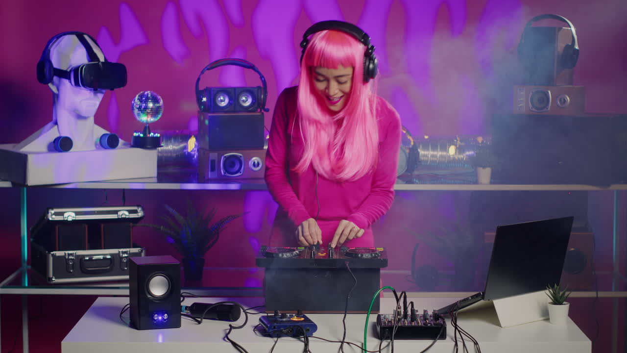 DJ with pink wig mixing music in studio