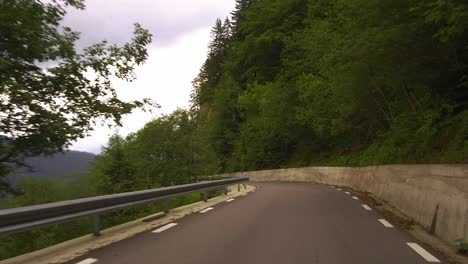 driving down a winding road at bucegi mountains with a great panorama view on the valley