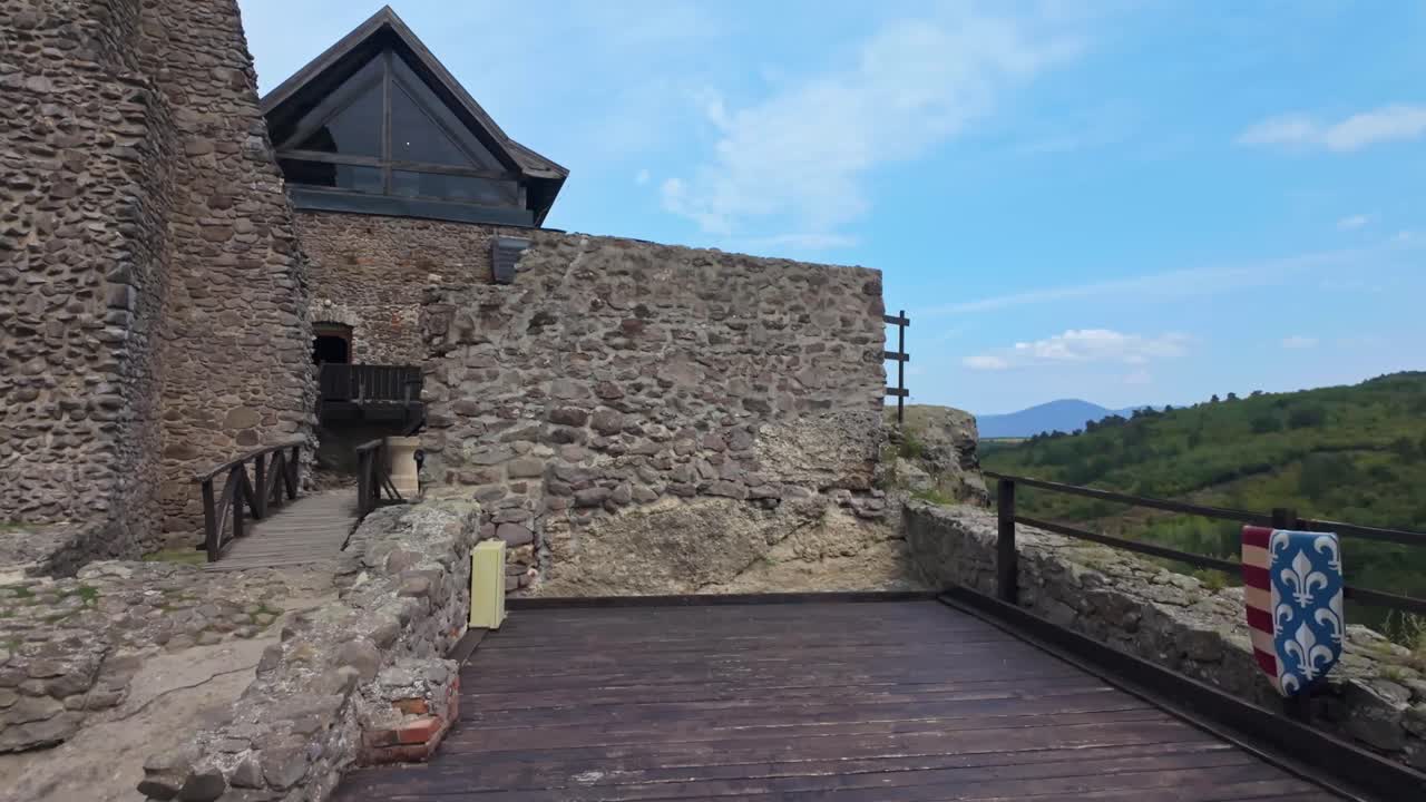 Pull-back view of Boldogkő Castle in Boldogkőváralja, Hungary, highlighting its medieval stone architecture, scenic natural surroundings, and rich historical heritage