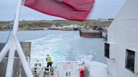 view from the back of a ferry leaving the coast of north scotland