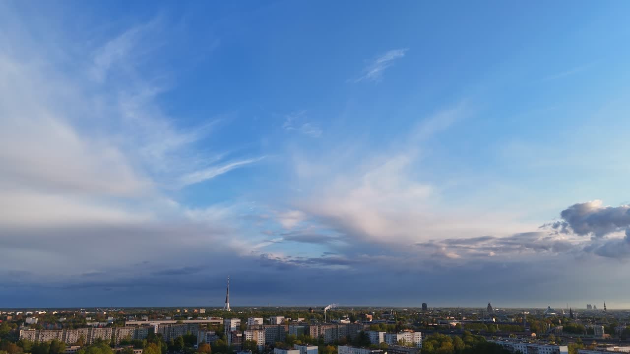 A smooth tilt reveals Riga’s skyline, transitioning from clear blue sky to urban beauty.
