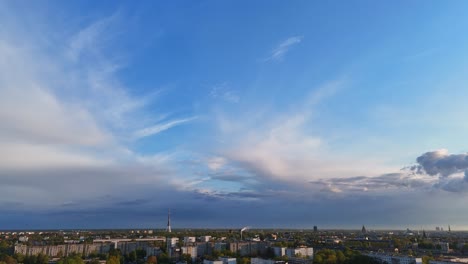 a smooth tilt reveals riga’s skyline, transitioning from clear blue sky to urban beauty.