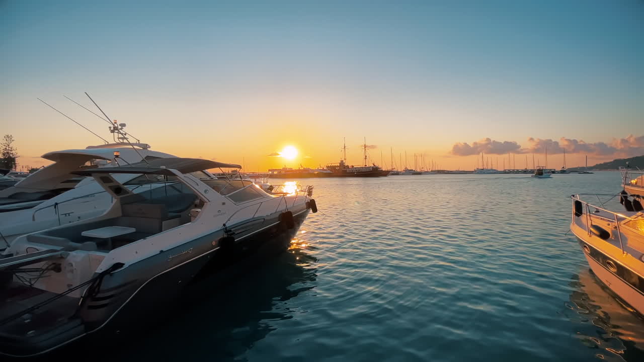 View of the Ionian Sea port of Zakynthos at sunset, Greece. Port with multiple moored boats. Slow motion