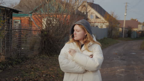 woman walking in a village in autumn