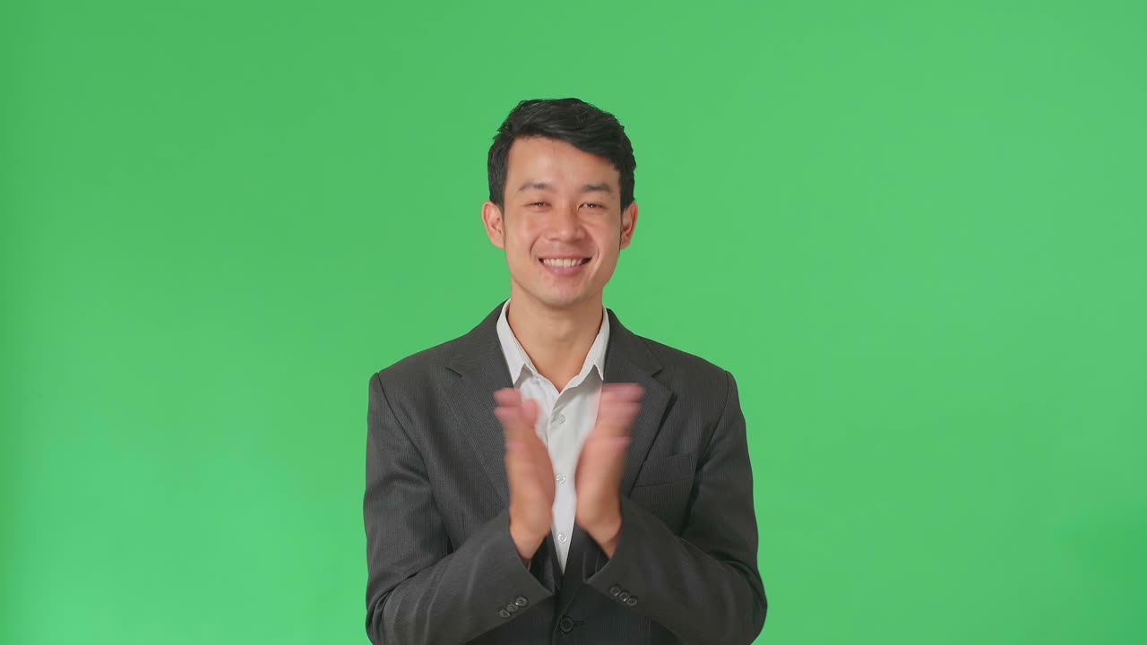 Young Asian Business Man Clapping Her Hands In The Green Screen Studio