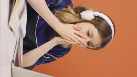 Vertical-video-of-Young-woman-looking-at-laptop-in-amazement.