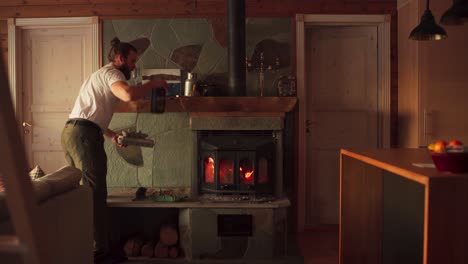 european man cleaning up fireplace in the house