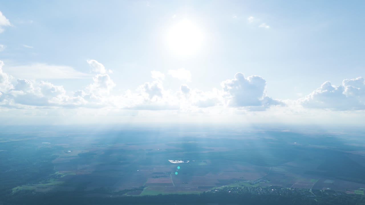 Sun rays shine through cloud layer, looks like heaven, aerial drone view