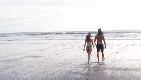 man and woman going to the sea