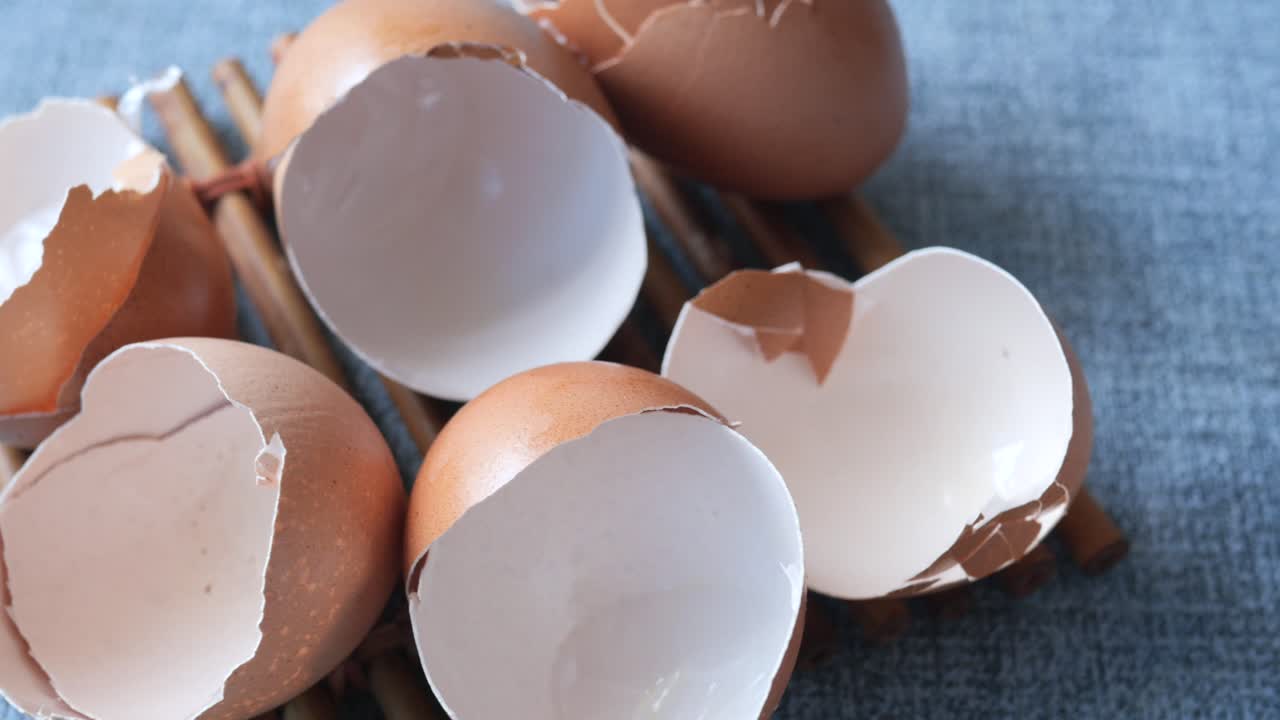 Eggshells in a white  bowl on table ,