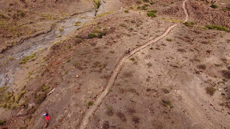 Person walking on pathway in desert looking landscape of Tenerife island